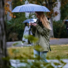 girl with umbrella in urban nature
